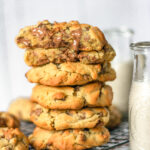 stack of bakery-style chocolate chip cookies on a wire rack