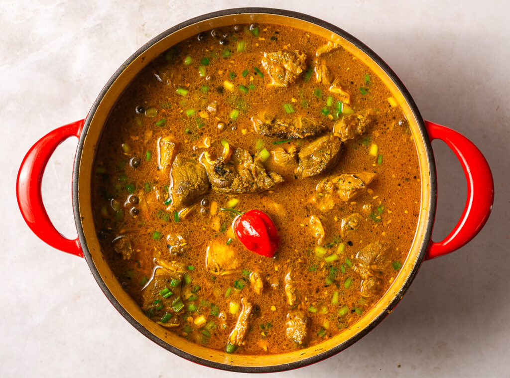 covering goat meat with vegetable stock before braising