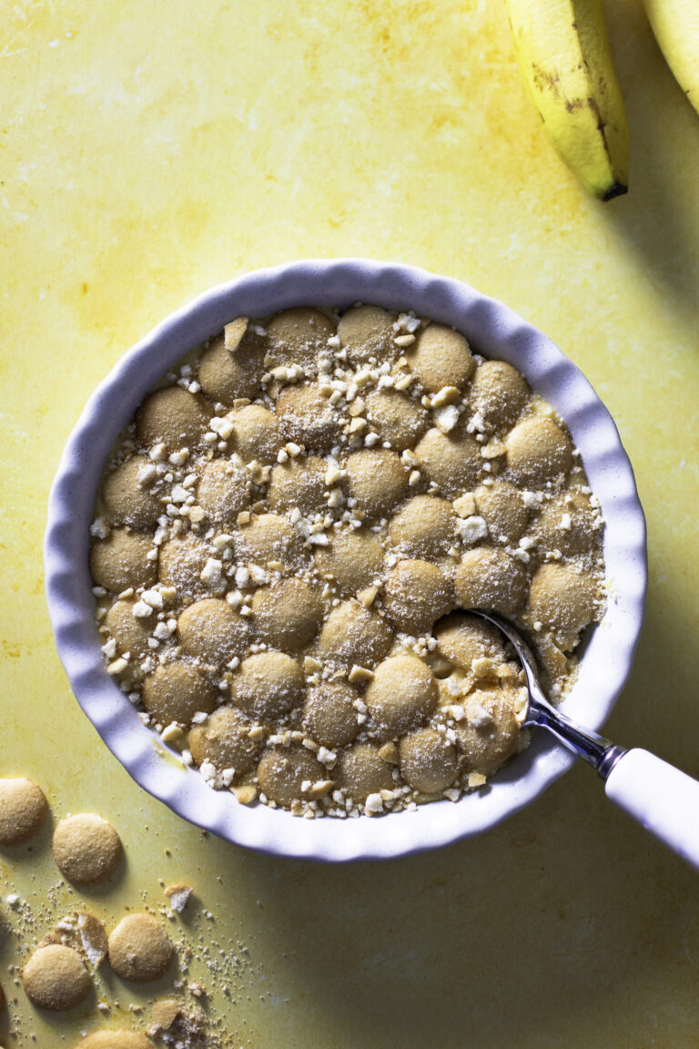 classic banana pudding topped with Nilla wafers being scooped