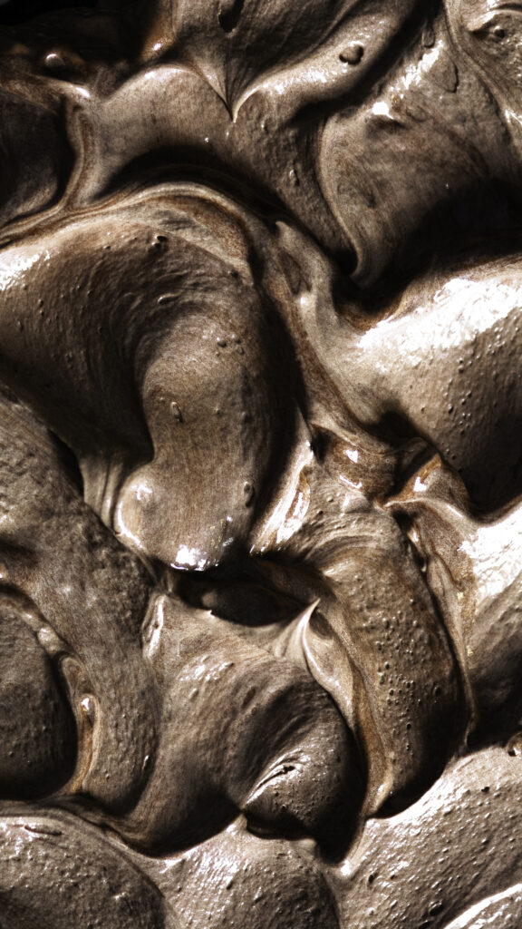 overhead close up of glossy milk chocolate ganache swirls