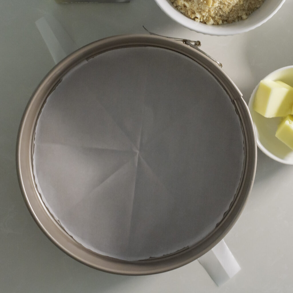 springform pan with parchment circle insert and 2 tabs for easy transfer