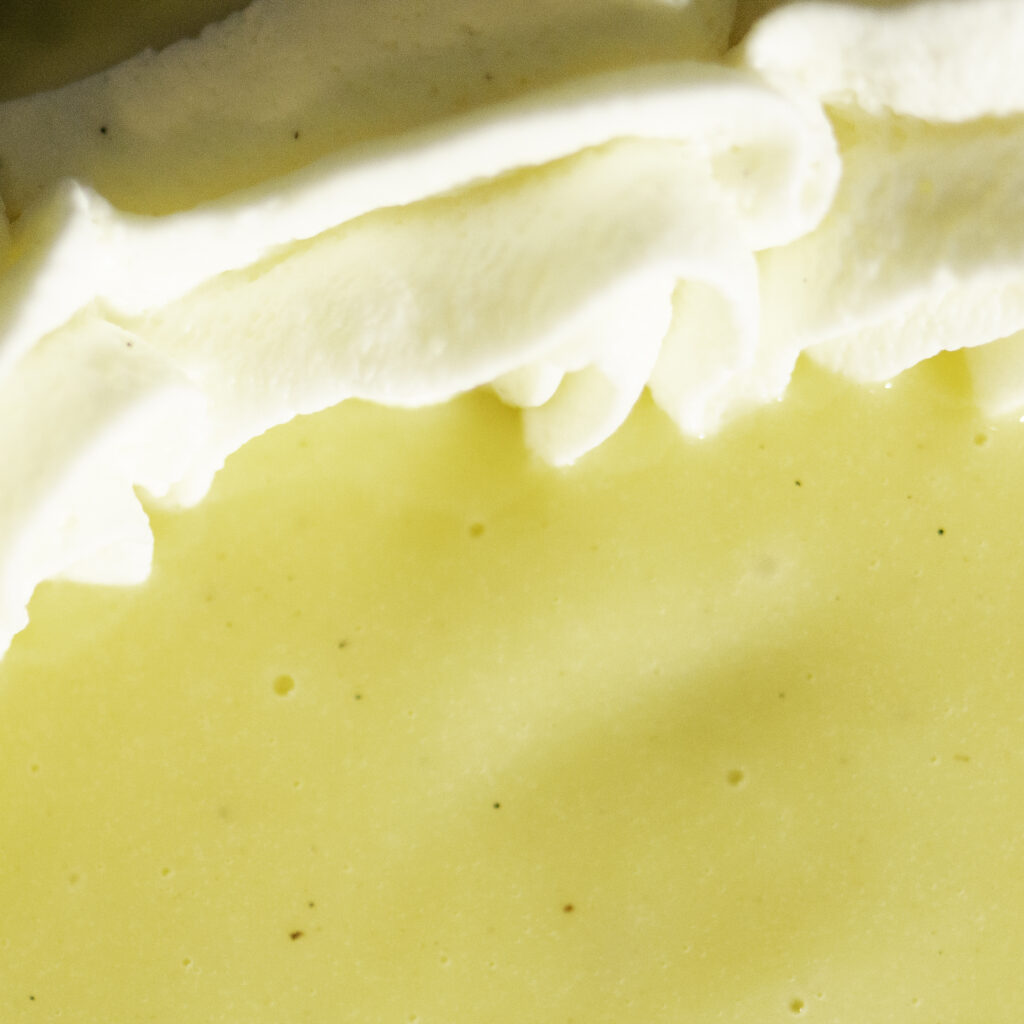 stabilized whipped cream border holding in custard for banana pudding cheesecake