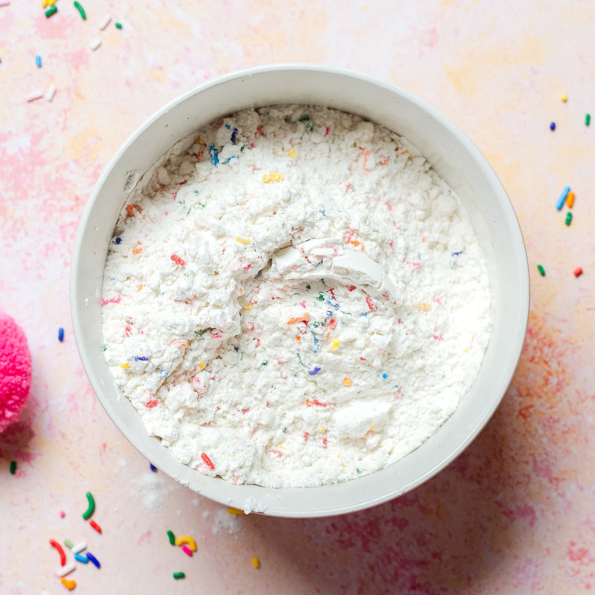 flour and sprinkle jimmies mixed in a bowl.