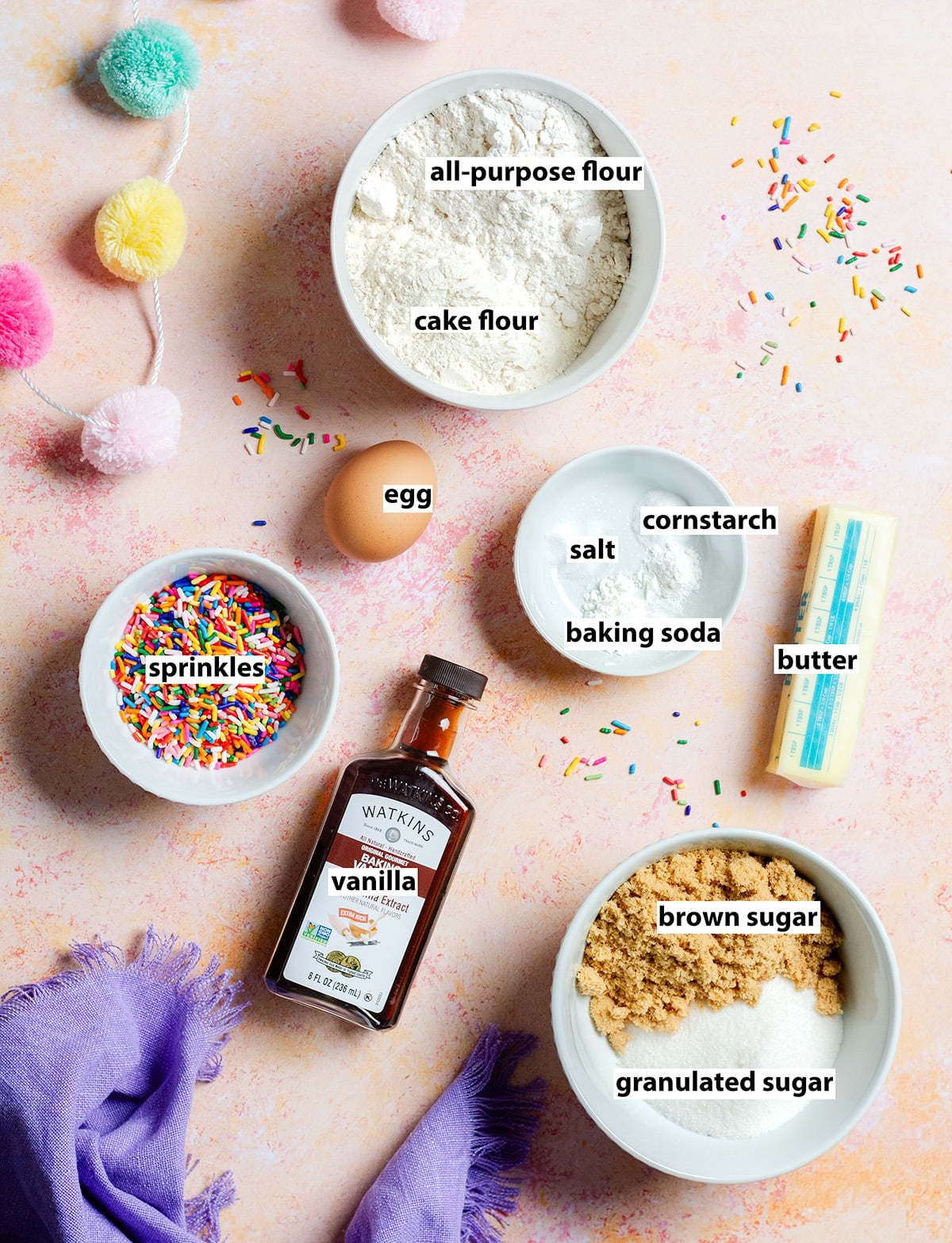 ingredients for confetti cookies - all-purpose flour, cake flour, egg, vanilla, sprinkles, brown sugar, granulated sugar, butter, salt, baking soda and cornstarch.