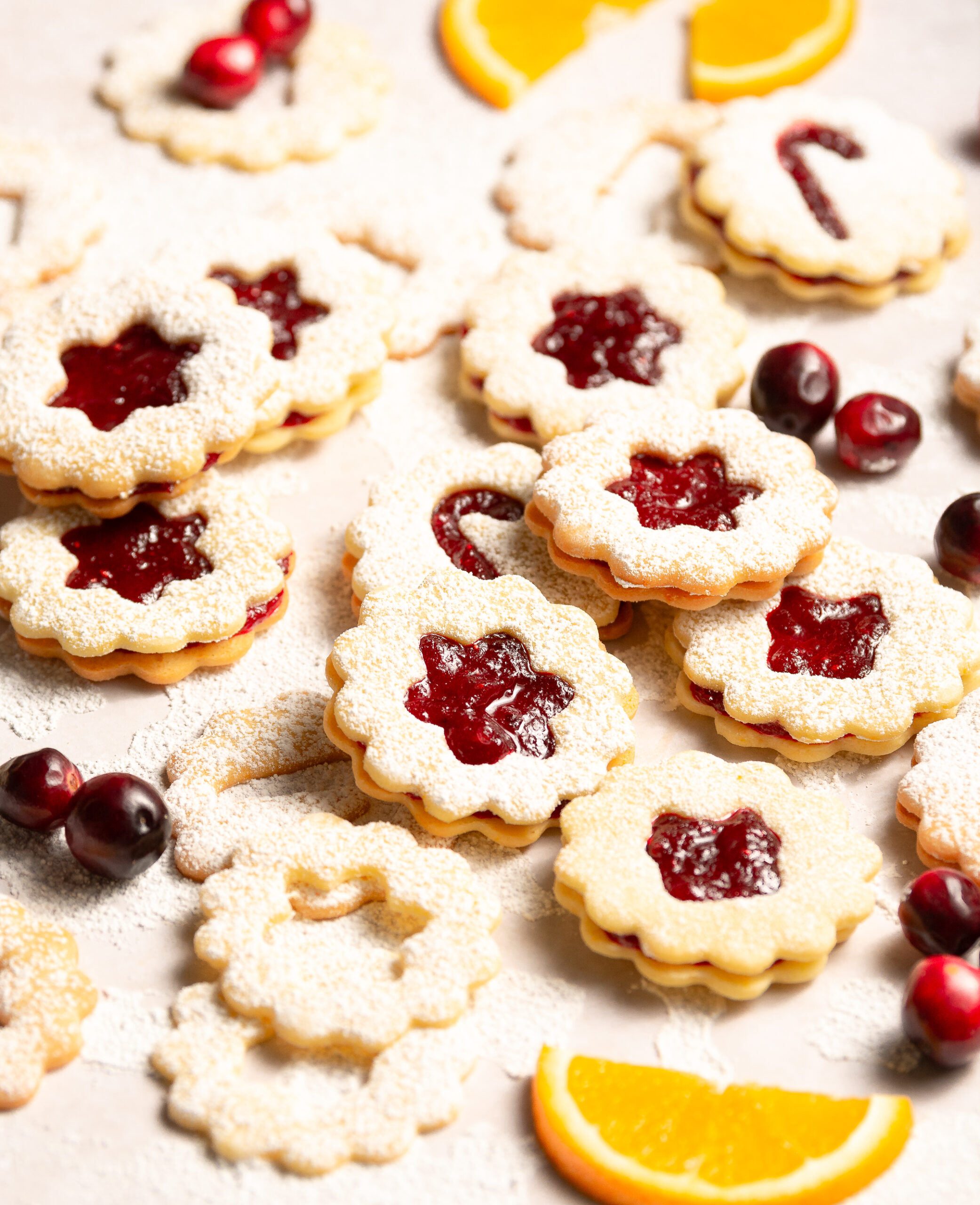 orange cranberry Linzer cookies with dusting of confectioner's sugar