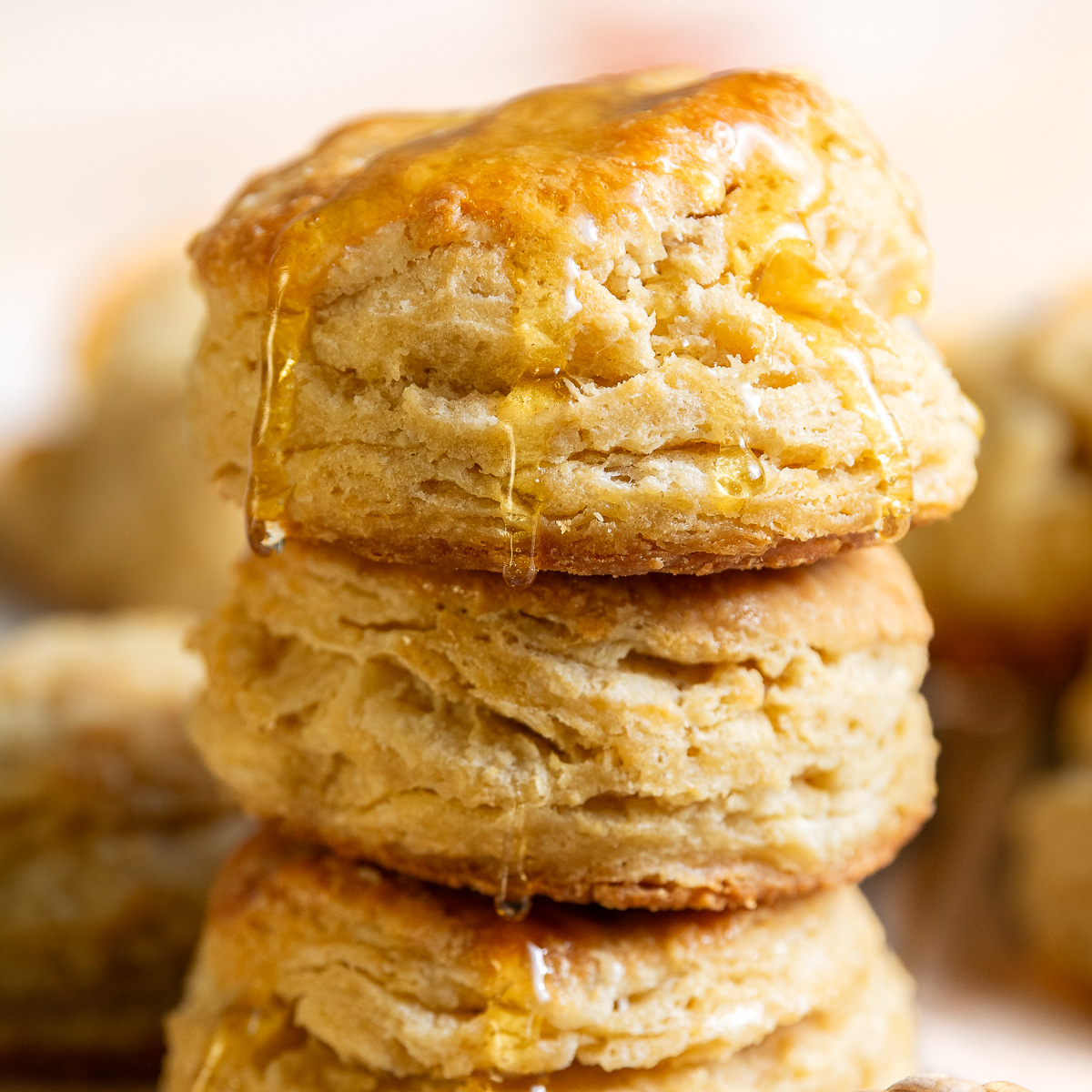 stack of buttermilk biscuits with honey drizzle.