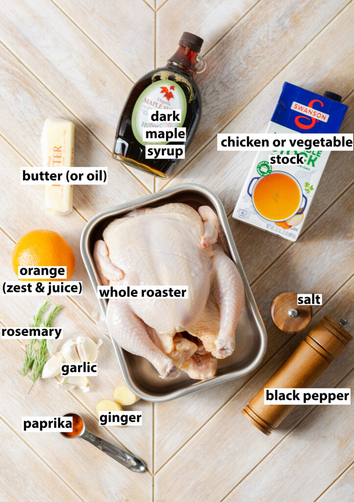 ingredients for a spatchcocked and whole roasted orange maple chicken - dark maple syrup, vegetable stock, butter, whole orange (juice & zest), rosemary, garlic, paprika, ginger, salt & black pepper