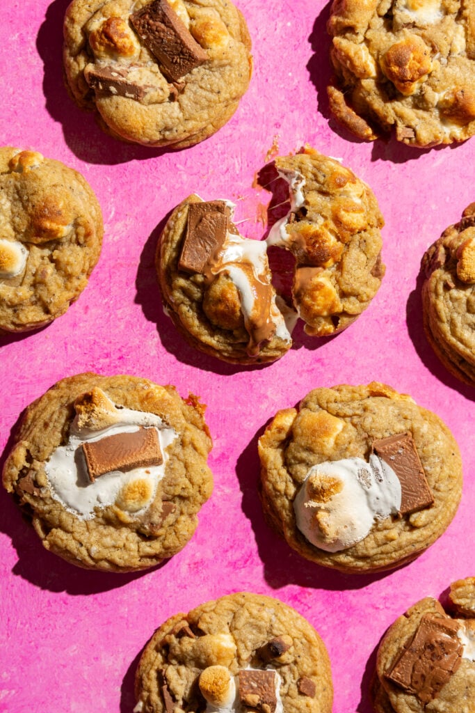 browned butter s'mores cookies on a pink background