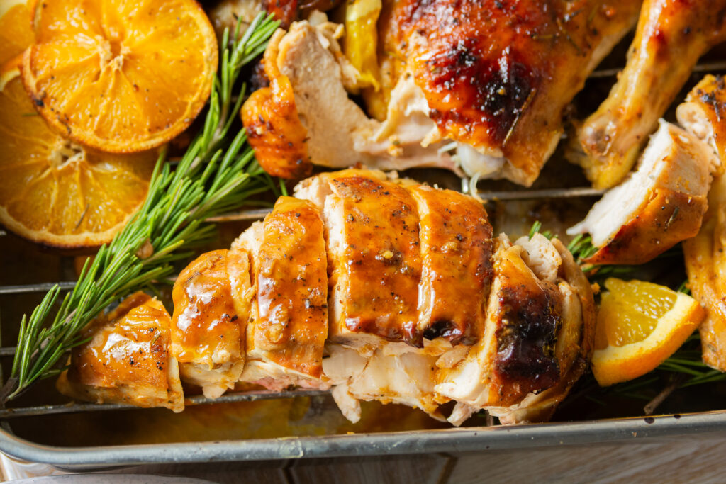 sliced breast of a spatchcocked and whole roasted orange maple chicken