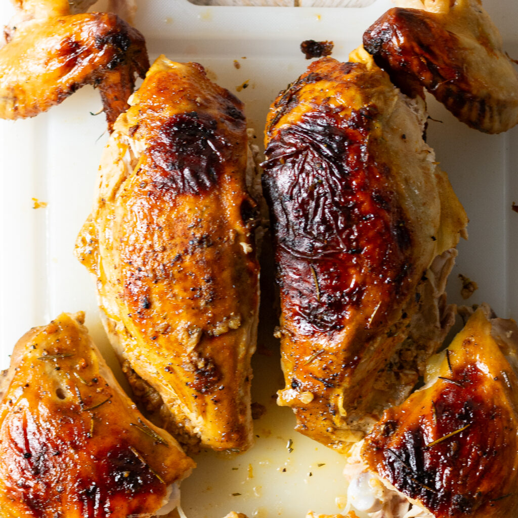 breaking apart a spatchcocked and whole chicken