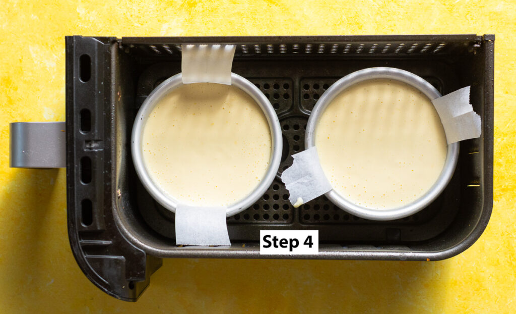 2 mini lemon cheesecakes in the basket of an airfryer