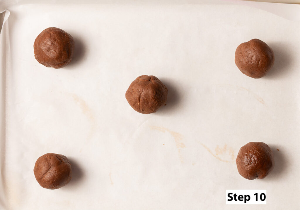 assembled chocolate lava cookie dough balls arrange on a parchment-lined baking sheet