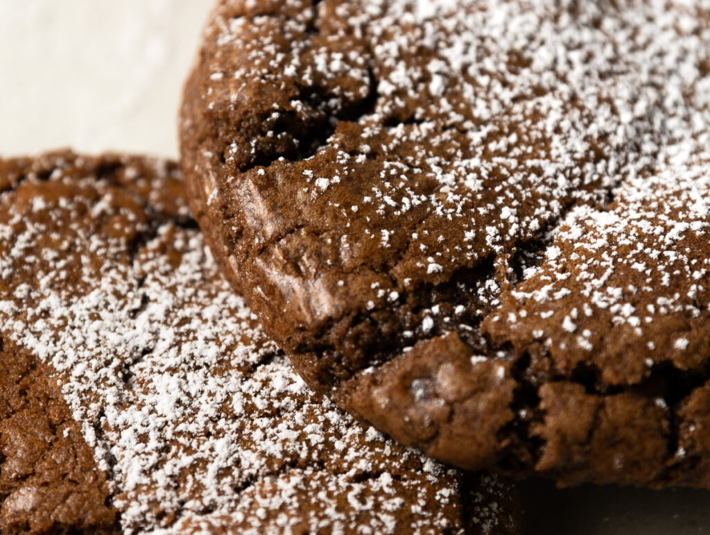 close up of chocolate lava cookies showing shiny crackle top similar to brownies