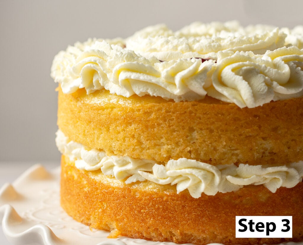 honey lemon cake layered with mascarpone whipped cream and raspberry preserve filling