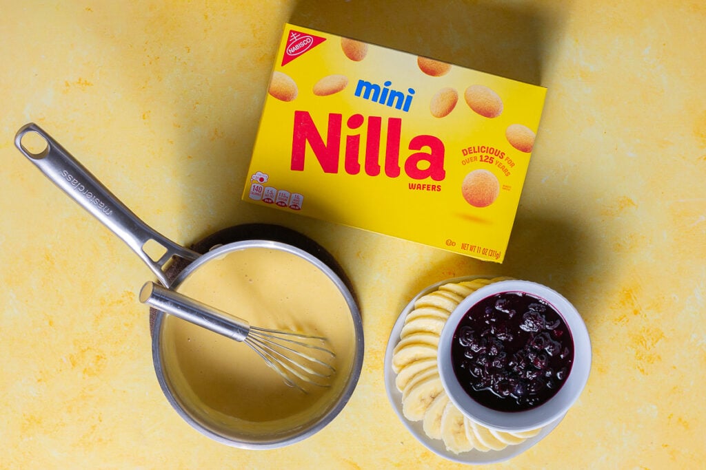 elements for lemon-blueberry banana pudding before assembly - Nilla wafer cookies, lemon custard, sliced bananas, blueberry compote