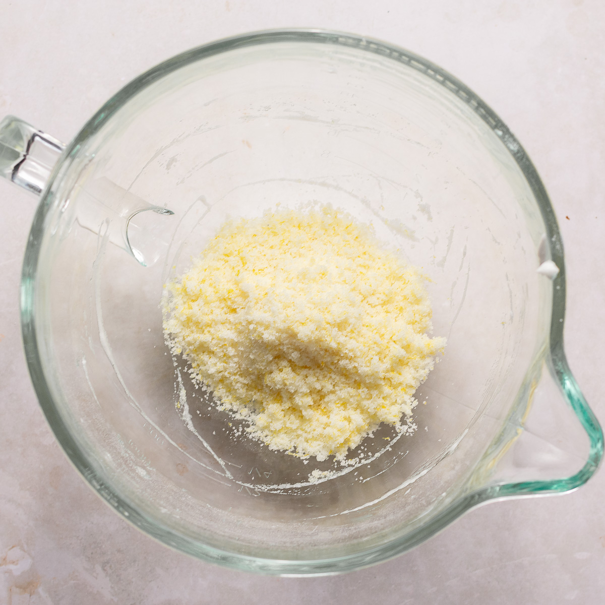 lemon zest rubbed into sugar in a glass bowl.