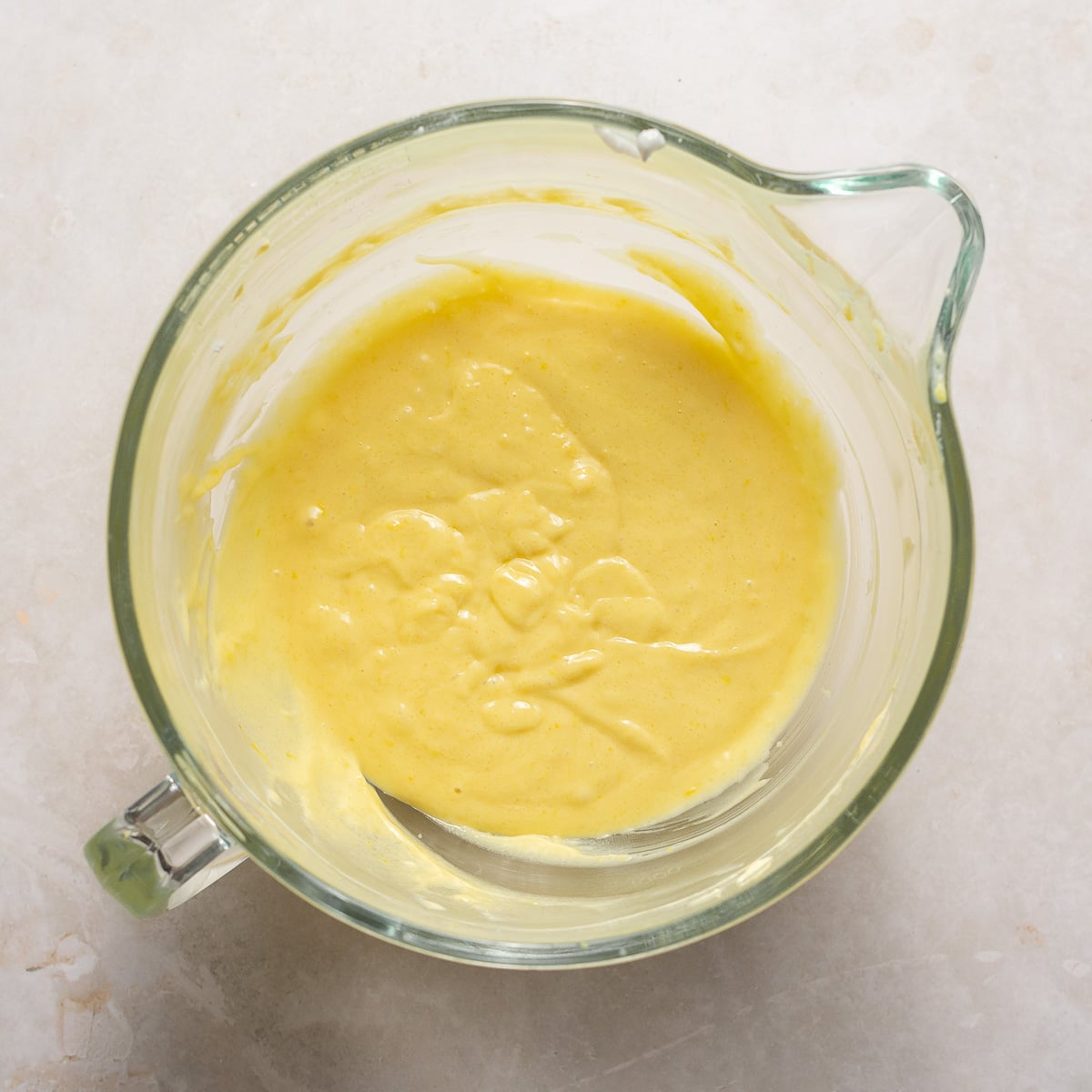 Adding the rest of the wet ingredients for lemon cupcake batter.