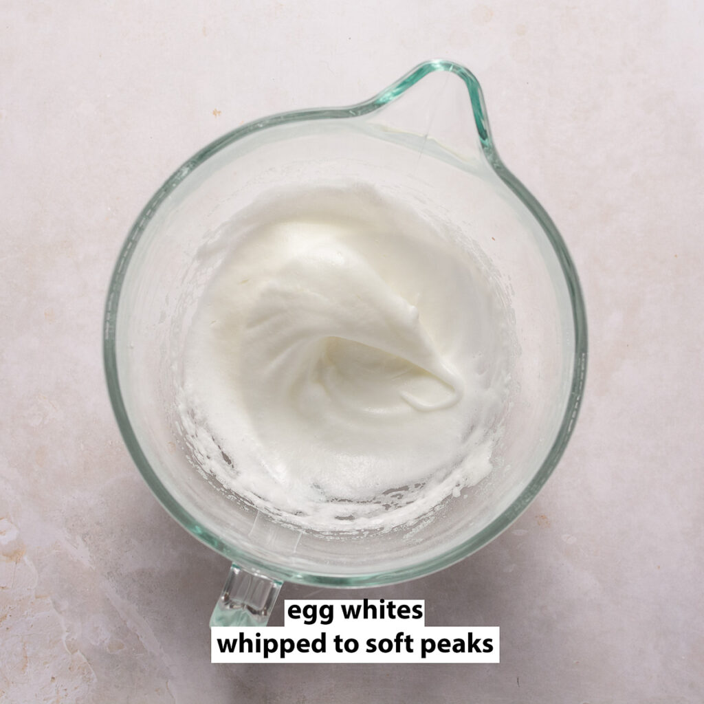 egg whites whipped to soft peaks in a glass bowl
