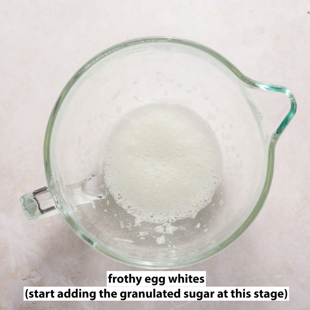frothy egg whites in a glass bowl