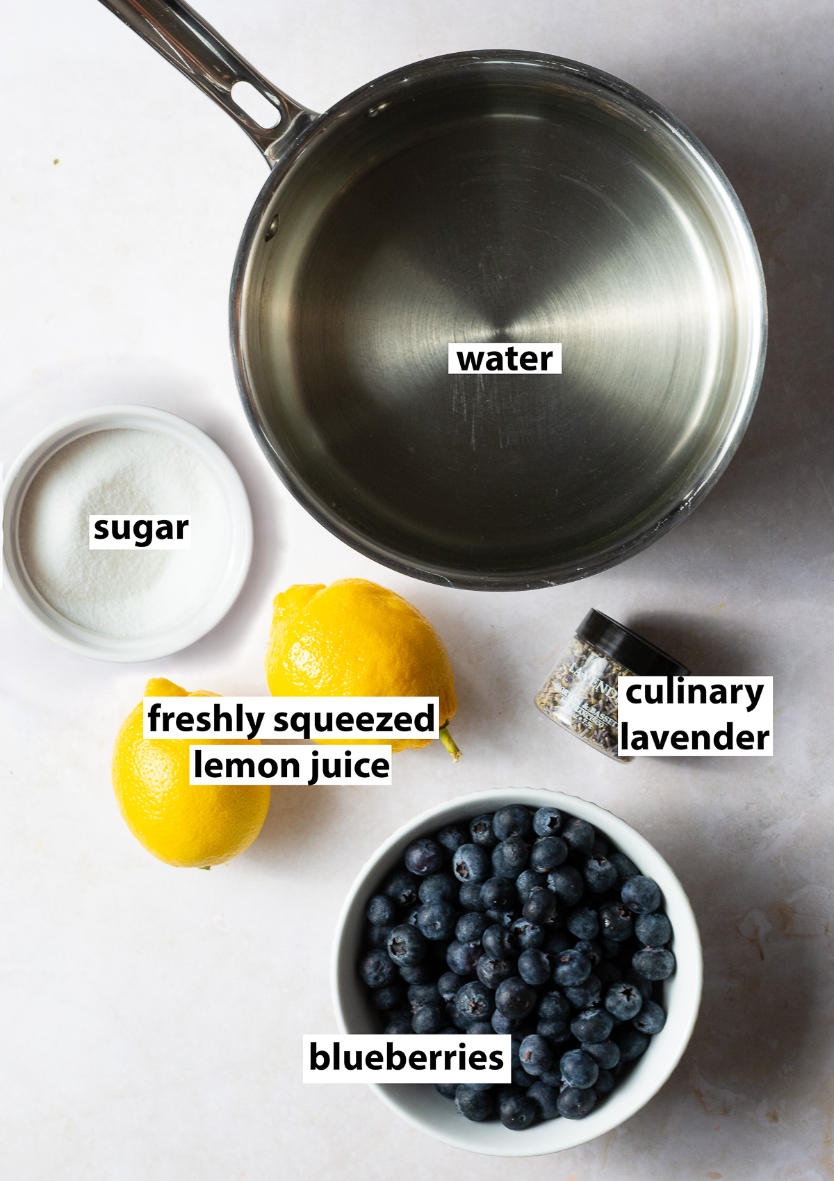 ingredients for blueberry lavender lemonade - lemon juice, blueberries, culinary lavender, sugar and water.