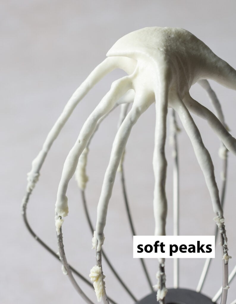 heavy cream whipped to soft peaks on a whisk
