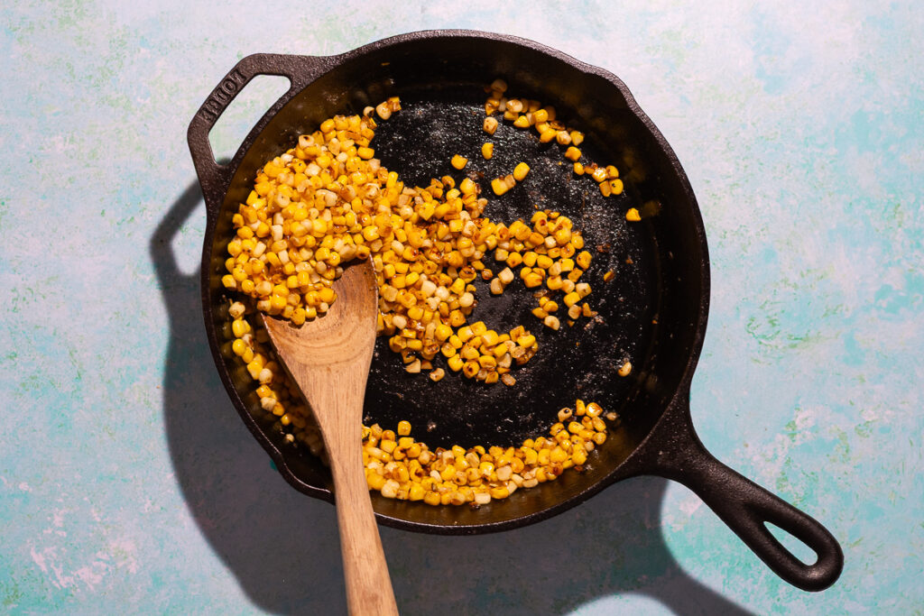 browned corn kernels in a cast iron pan