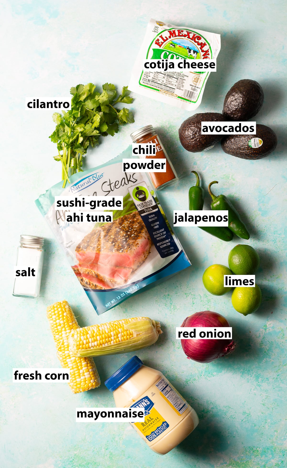 ingredients for fresh tuna  dip with elote & guac - ahi tuna, fresh corn, avocados, cilantro, jalapeños, red onion, mayonnaise, lime juice, chili powder, cilantro, cotija cheese & salt