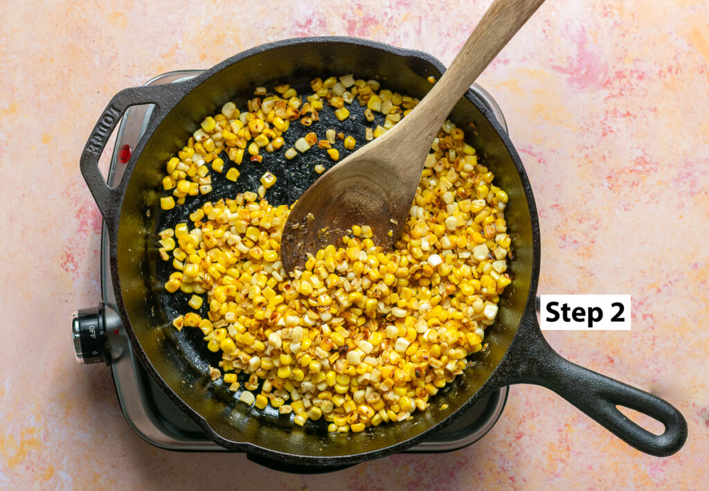 cooked corn kernels in a cast iron pan for Mexican street corn potato salad
