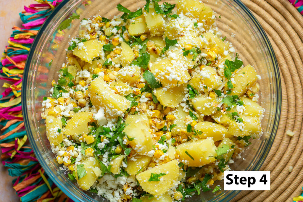 cubed potatoes, corn, cilatro & cotija cheese in a glass bowl