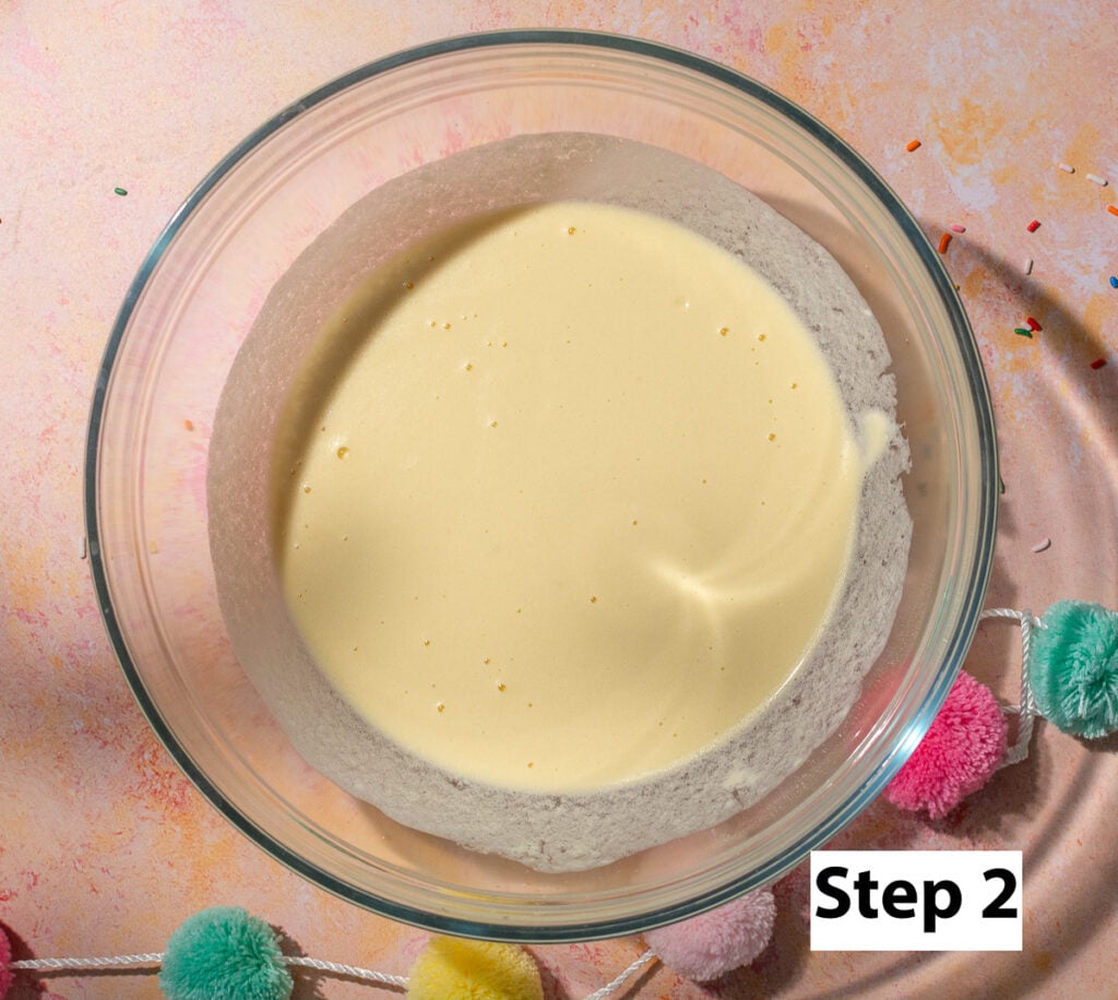 wet ingredients mixed in a bowl for a funfetti snack cake