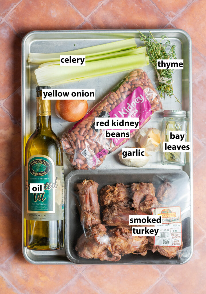 ingredients for southern style red beans - red kidney beans, smoked turkey, bay leaves, garlic, oil, yellow onion, thyme & celery