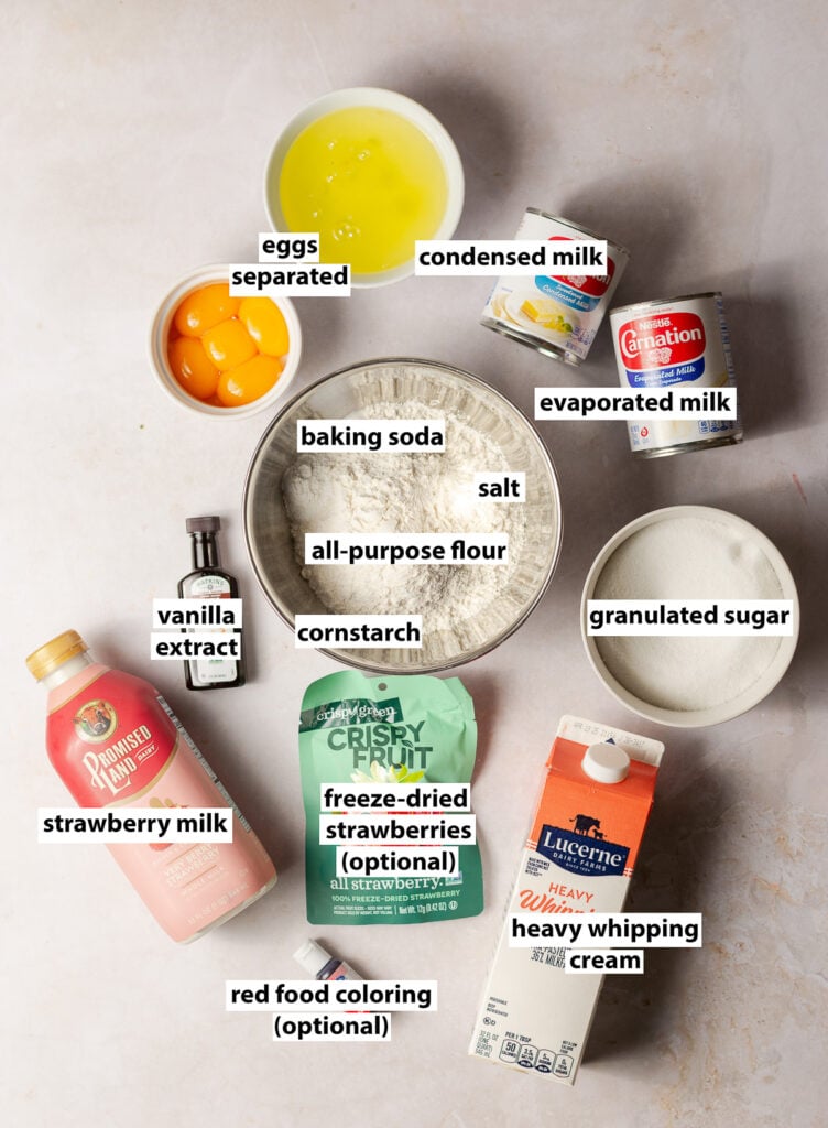 ingredients for strawberry tres leches cake - all-purpose flour, baking powder, salt, cornstarch, strawberry milk, separated eggs, vanilla extract, granulated sugar, evaporated milk, condensed milk optional freeze-dried strawberries & optional food coloring