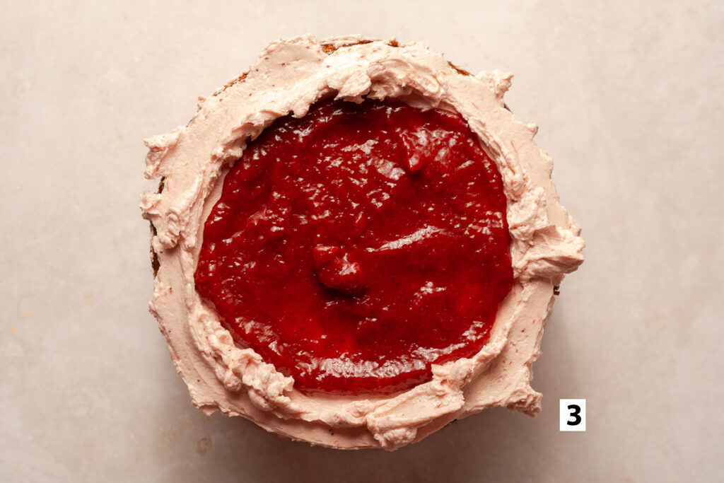 strawberry reduction filling in a strawberry Swiss meringue buttercream well