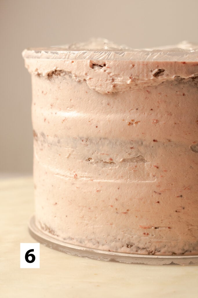 triple strawberry layer cake with a crumb coat