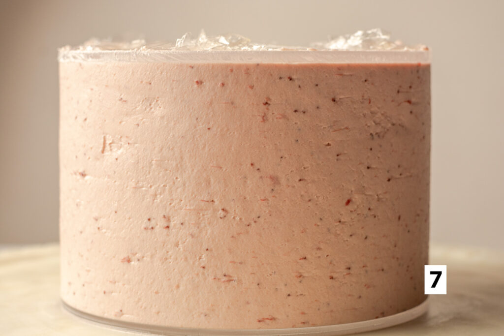 triple strawberry layer cake with final coat of strawberry Swiss meringue buttercream