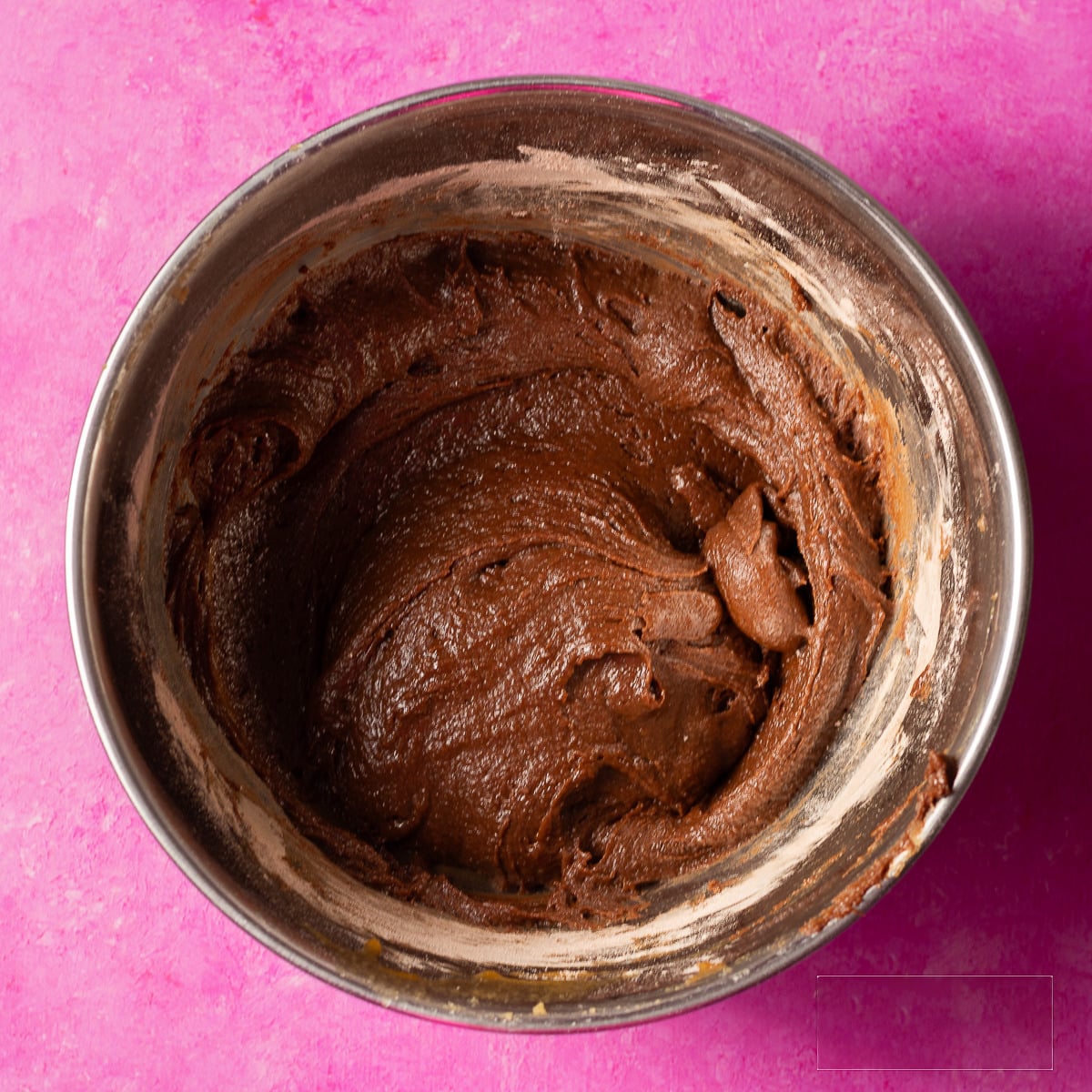 chocolate cookie dough in a stainless steel bowl.