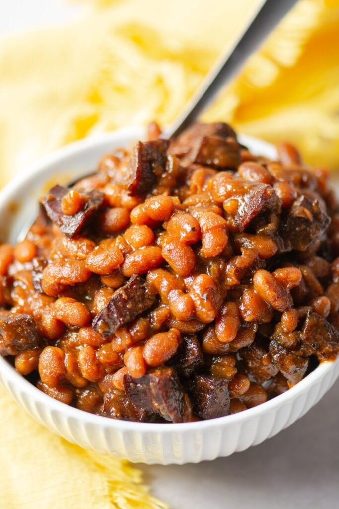 maple barbecue baked beans in a bowl with a spoon