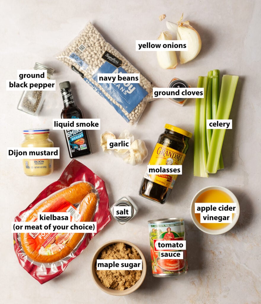 ingredients for maple barbecue baked beans - navy beans, kielbasa, celery, yellow onion, garlic, maple sugar, Dijon mustard, molasses, apple cider vinegar, tomato sauce, cloves, black pepper and salt