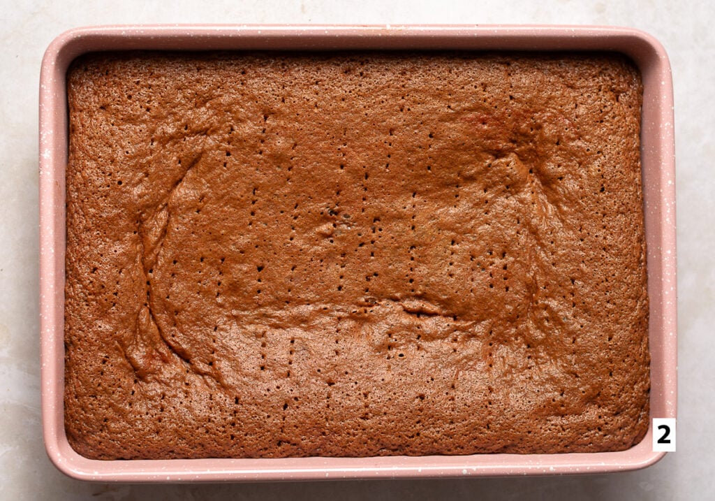 red velvet sponge cake with fork holes poke into it for a tres leches cake