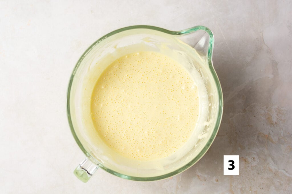 whipped eggs in a glass mixing bowl