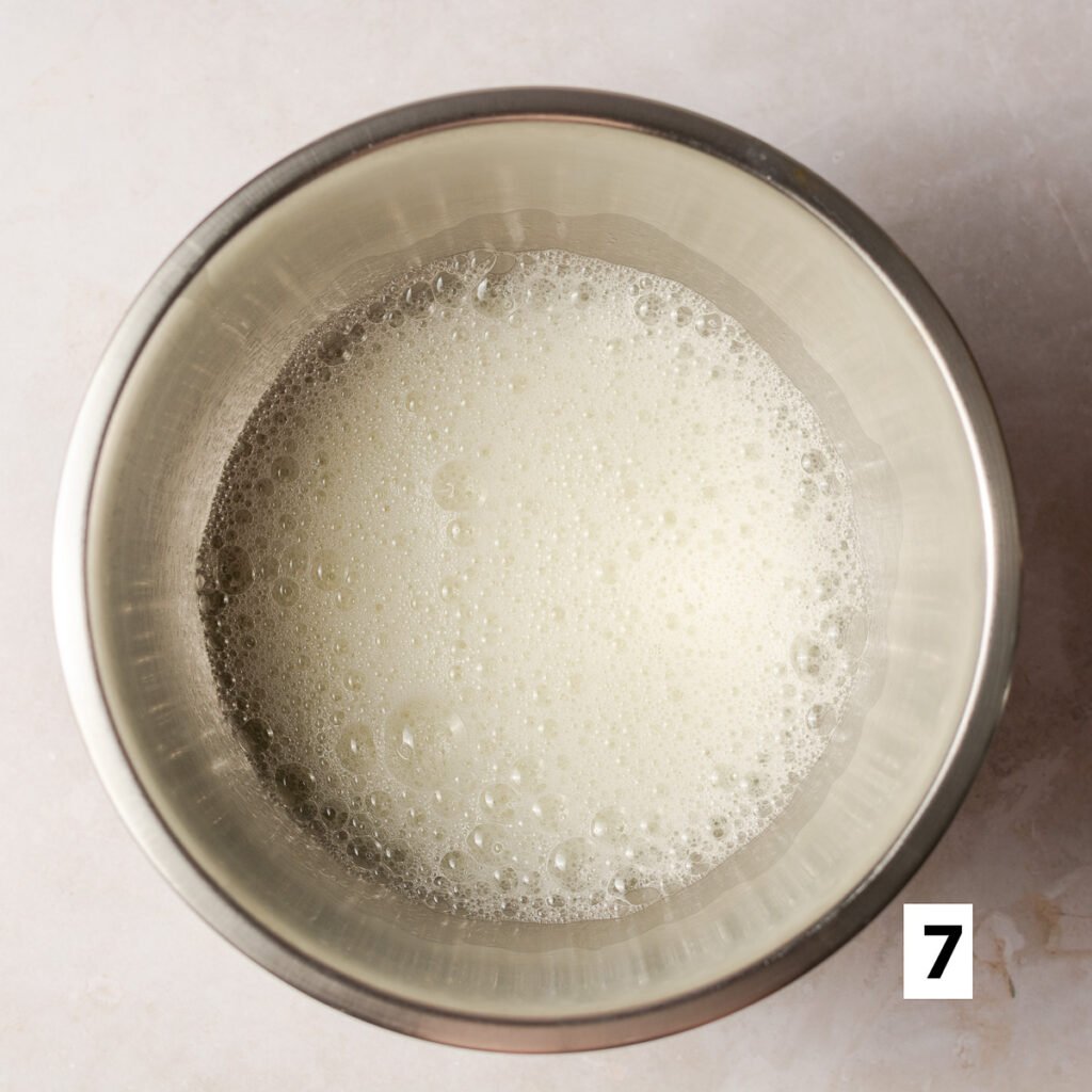 foamy egg whites in a bowl