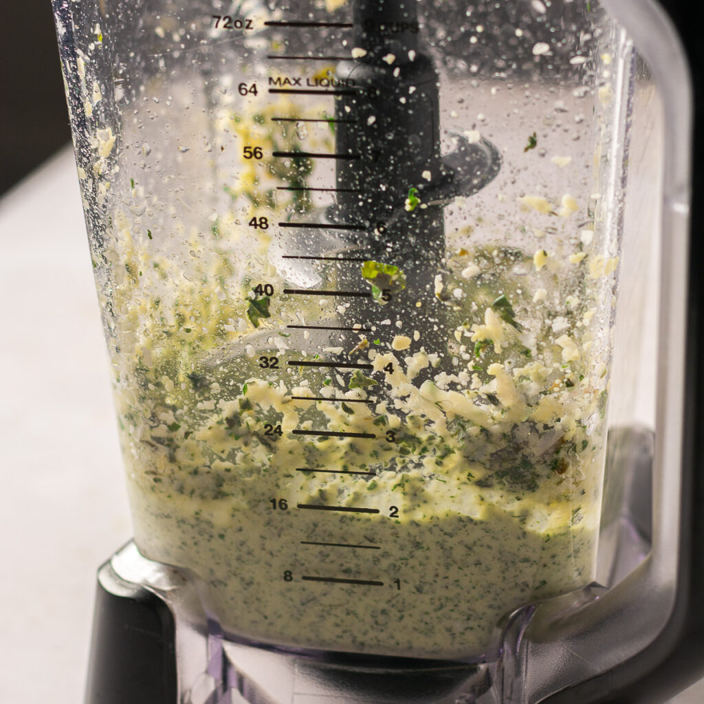classic basil pesto in the middle of pureeing