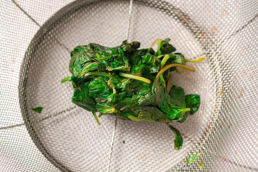 clump of basil squeezed to remove the excess water after blanching
