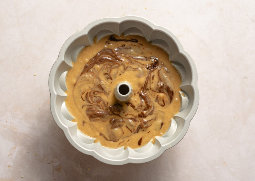 marbled chocolate banana batter in a bundt cake pan