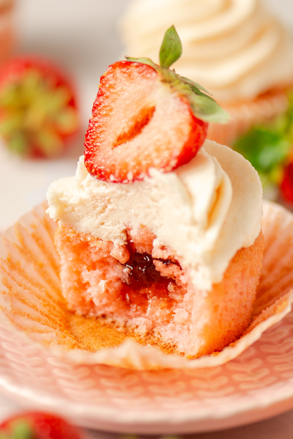 strawberry cupcakes topped with strawberry buttercream and strawberry preserves