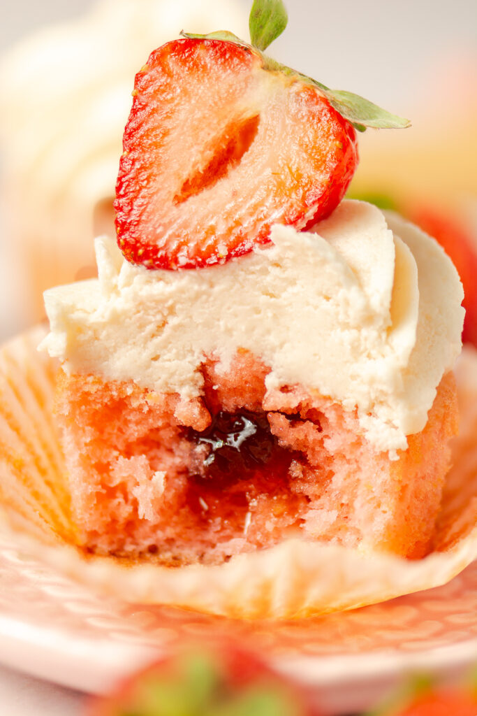 strawberry cupcakes topped with strawberry buttercream and strawberry preserves