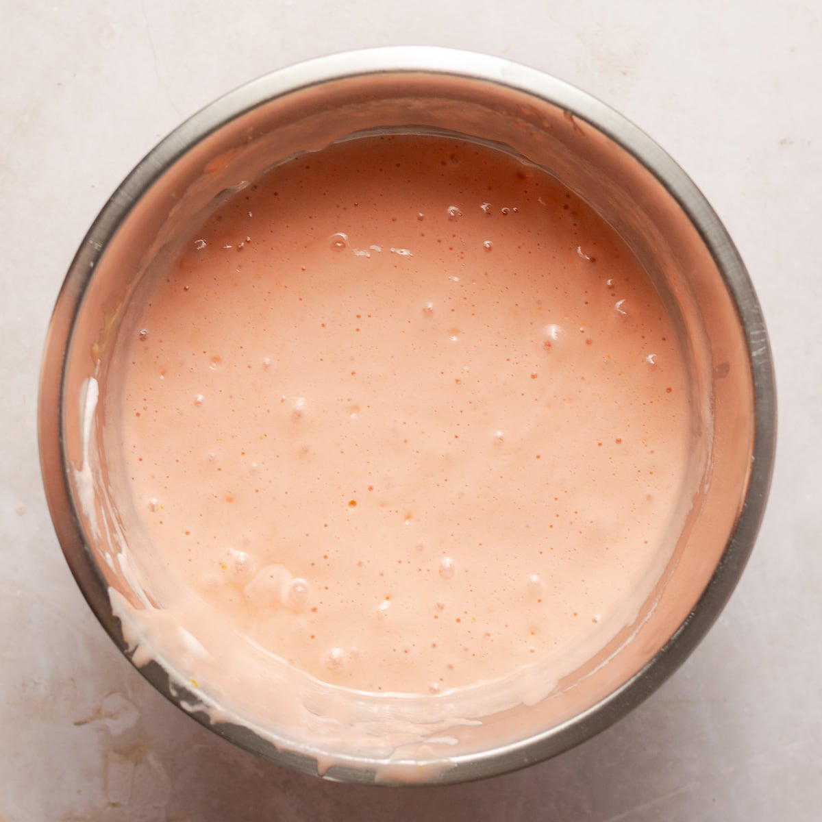 strawberry cupcake batter in a stainless steel bowl.