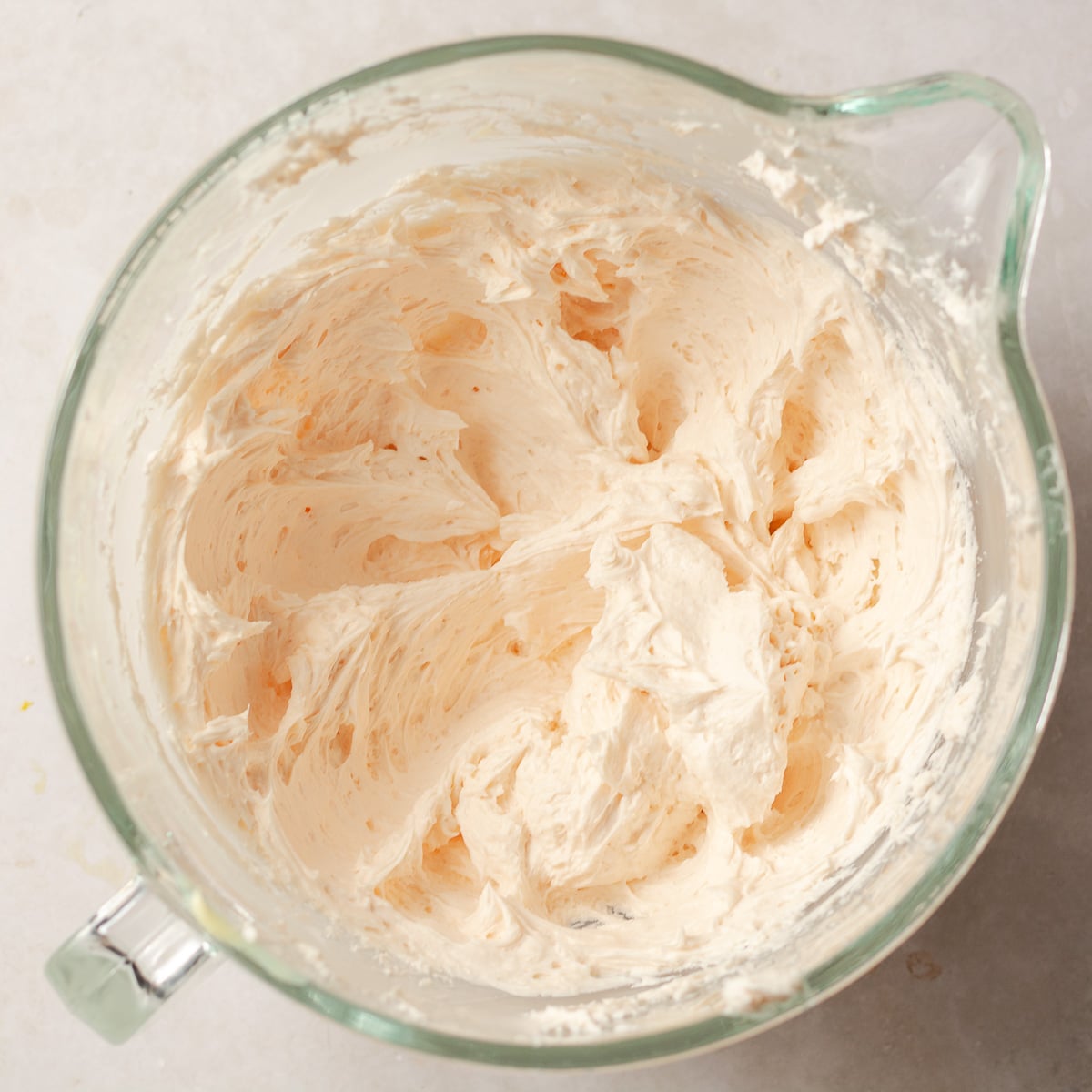 strawberry buttercream in a glass mixing bowl.