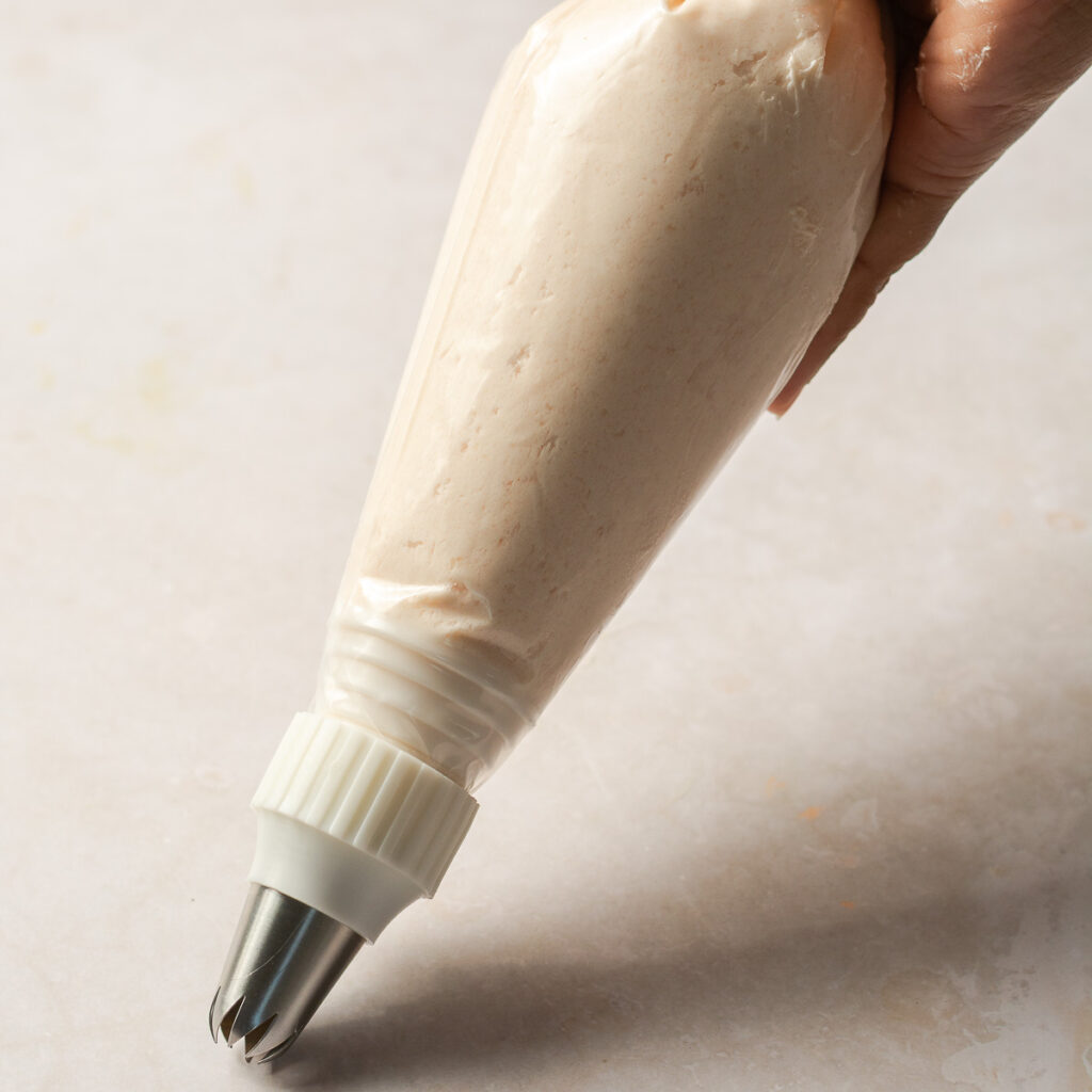 strawberry ermine buttercream in a piping bag