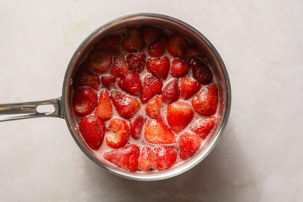 strawberry and strawberry syrup in a saucepan
